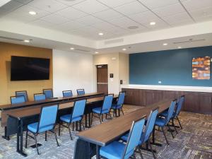 a conference room with a long table and blue chairs at Hampton Inn Redmond Bend Airport in Redmond