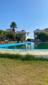 a swimming pool in front of a house at luxury condo with sea view in Tangier
