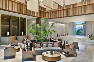 a lobby of a hotel with couches and chairs at Conrad Rabat Arzana in Rabat