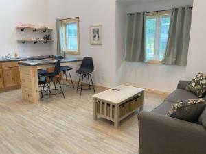 a living room with a couch and a table at Bluffside Gardens in Decorah
