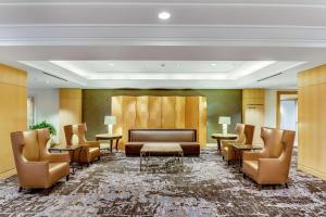 a lobby with a couch and chairs and tables at Hilton Los Angeles Airport in Los Angeles