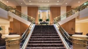 a staircase in a building with escalators at Hilton Los Angeles Airport in Los Angeles