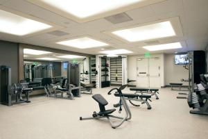 a gym with many exercise equipment in a room at Hilton Los Angeles Airport in Los Angeles