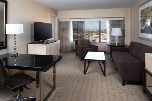 a living room with a couch and a tv at Hilton Los Angeles Airport in Los Angeles