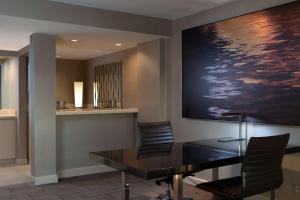 a conference room with a table and chairs and a painting at Hilton Los Angeles Airport in Los Angeles