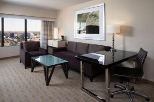 a living room with a couch and a table at Hilton Los Angeles Airport in Los Angeles