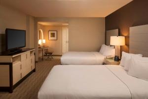 a hotel room with two beds and a flat screen tv at Hilton Los Angeles Airport in Los Angeles