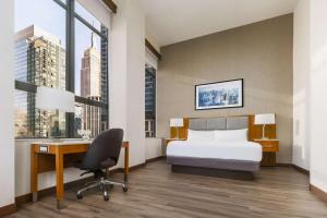 a hotel room with a bed and a desk with a computer at DoubleTree by Hilton Hotel New York City - Chelsea in New York