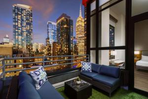 a balcony with a view of a city skyline at DoubleTree by Hilton Hotel New York City - Chelsea in New York