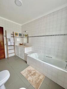 y baño con bañera, lavabo y aseo. en A Villa Fortuna, en Santo André