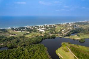 an aerial view of a lake with trees and the ocean at Indura Beach & Golf Resort Curio Collection By Hilton in Tela