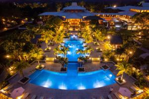 an aerial view of a resort pool at night at Indura Beach & Golf Resort Curio Collection By Hilton in Tela