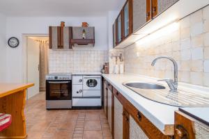 a kitchen with a sink and a stove at Apartments for families with children Prezid, Gorski kotar - 20260 in Prezid +14 photos