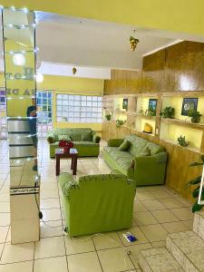 a large living room with green couches and a table at HOTEL CASA DEL REY!! in Arriaga