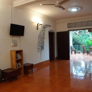 a living room with a flat screen tv on the wall at SRL Villa in Phumi Ta Phul