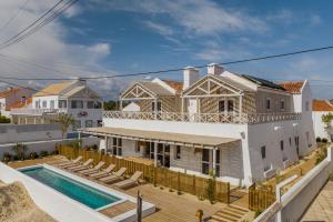 a villa with a swimming pool and a house at Villa da Comporta - Quarto Praia da Comporta T0 in Comporta
