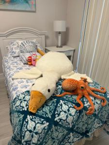 a bed with a bunch of stuffed animals on it at Naples Dream at WTC with Heated Pool SPA Sauna 7 bicycles and 3 mls to beach in Naples