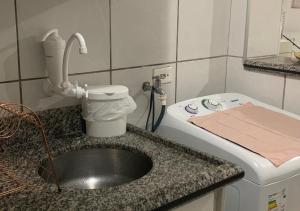 a kitchen counter with a sink and a toilet at Studio completo com vaga entre o Centro e Cambuí in Campinas