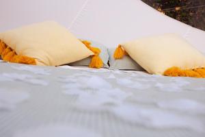 Una cama con dos almohadas encima. en La Bolla di Mag en Saponara Villafranca