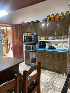 a kitchen with wooden cabinets and a counter top at Casa da Joci in Bonito