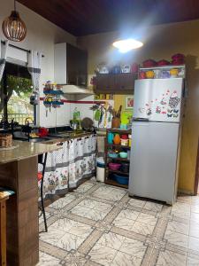 uma cozinha com um frigorífico branco num quarto em Casa da Joci em Bonito
