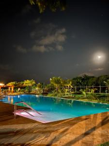 an empty swimming pool at night at Praia do forte - Villa do lago in Praia do Forte