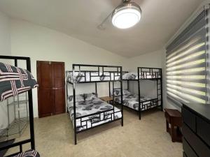 a room with three bunk beds in a room at Villa Colinas Del Cielo in San Cristóbal