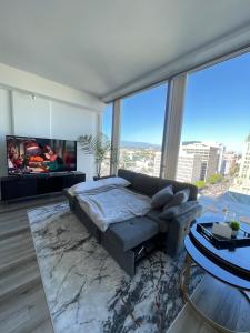 a bedroom with a bed and a large window at High Rise Studio in Heart of Ktown DTLA in Los Angeles