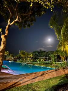 a swimming pool in a resort at night at Praia do forte - Villa do lago in Praia do Forte