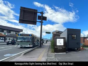 a bus is stopped at a bus stop at Mt. Fuji Glamping MOONLIGHT VILLA Kawaguchik in Fujikawaguchiko