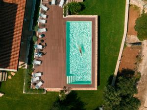 an overhead view of a swimming pool with parked cars at TerraCieloMare Apartments in Monopoli