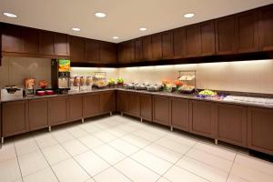 a large kitchen with wooden cabinets and a buffet at Residence Inn Baltimore Hunt Valley in Hunt Valley