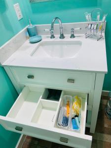 a white bathroom sink with a drawer under it at Beautiful and comfortable rom apt # 2 in Tampa