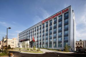 a building with a sign on the side of it at Hilton Garden Inn Changchun Economic Development Zone in Changchun