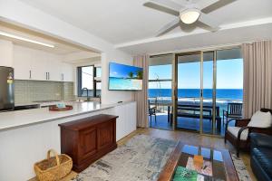 a kitchen and living room with a view of the ocean at Beachfront on Werrina in Blue Bay 