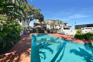 a swimming pool in a yard with a house at Beachfront on Werrina in Blue Bay 