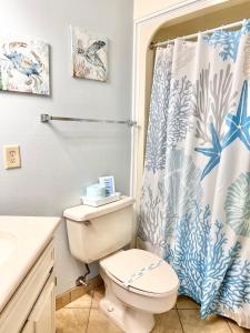 a bathroom with a toilet and a shower curtain at Elegant Coastal Getaway Spacious 3BR Chelsea House in Myrtle Beach