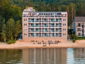 a large building on the beach next to the water at Alexandra Inn in Traverse City