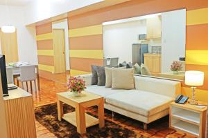 a living room with a couch and a table at Prince Plaza II Condotel in Manila