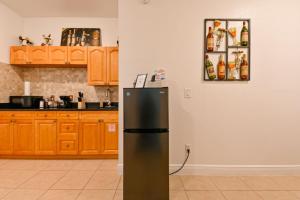 a kitchen with a black refrigerator in a room at Paradise in Brandon with luxurious 6 person Spa in Brandon
