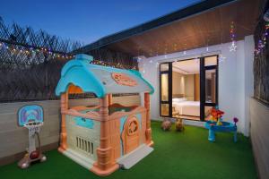 a toy house with a basketball hoop and a playground at Courtyard by Marriott Shanghai International Tourism and Resorts Zone in Shanghai