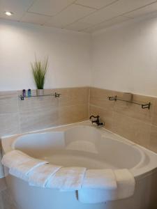 a large white bath tub in a bathroom at Ferienhaus am Bornfeld in Leimen