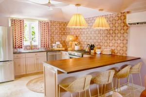 a kitchen with a wooden counter top in a room at Fig Tree Harbour Island home in Harbour Island