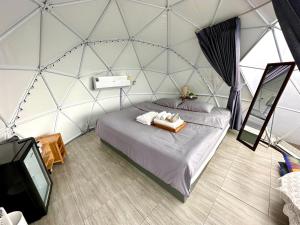 um quarto com uma cama e uma televisão numa tenda em Style Paidoi Resort em Ban Pa Yang (3)