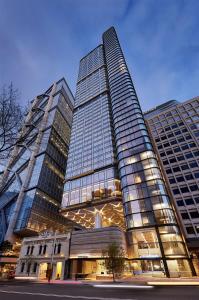 a tall building with many windows in a city at Citadines Walker North Sydney in Sydney