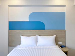 Postel nebo postele na pokoji v ubytování HOP INN Udonthani