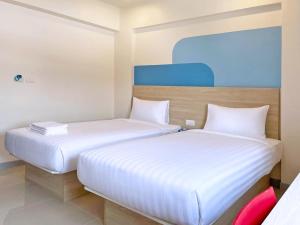 Postel nebo postele na pokoji v ubytování HOP INN Udonthani