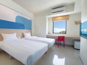 Postel nebo postele na pokoji v ubytování HOP INN Udonthani + 14 fotografií