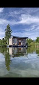 a tiny house sitting on top of a body of water at Dzintarkrasts in Jūrmala