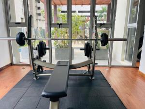 a gym with a barbell in front of a window at Great Escape in Colombo